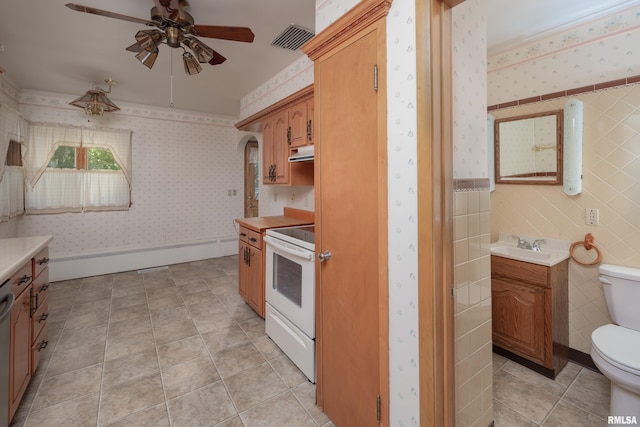1635 Eastmere Dr, Davenport, IA 52803 - kitchen featuring electric stove, wallpapered walls, a ceiling fan, under cabinet range hood, and light countertops