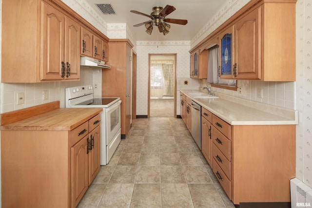 1635 Eastmere Dr, Davenport, IA 52803 - kitchen with electric stove, under cabinet range hood, ceiling fan, wallpapered walls, and stainless steel dishwasher