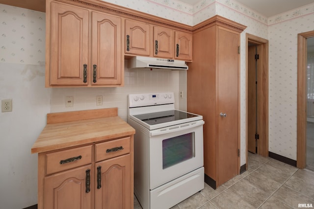 1635 Eastmere Dr, Davenport, IA 52803 - kitchen with white electric range, under cabinet range hood, wallpapered walls, light tile patterned floors, and butcher block counters