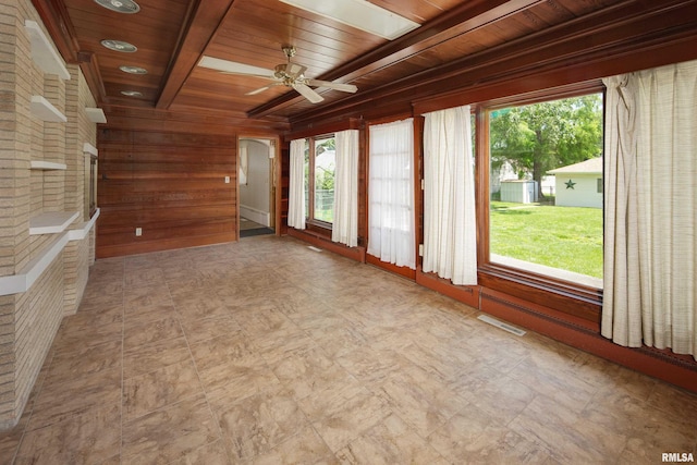 1635 Eastmere Dr, Davenport, IA 52803 - spare room featuring a wood ceiling with exposed beams, wooden walls, ceiling fan, light floors, and arched walkways