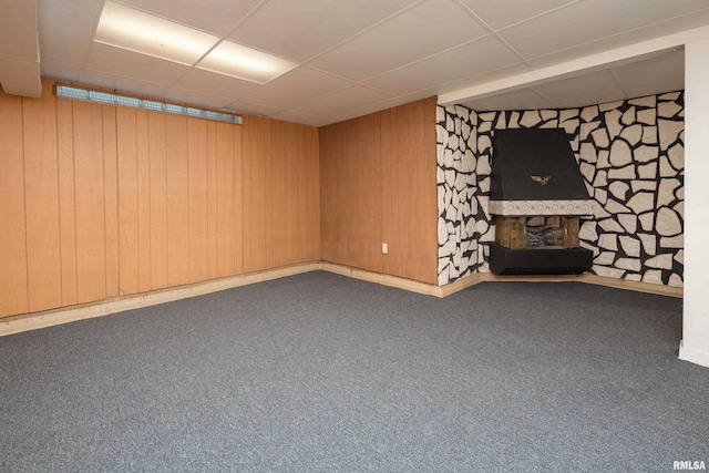 1635 Eastmere Dr, Davenport, IA 52803 - finished below grade area featuring a paneled ceiling, a fireplace, wood walls, and carpet flooring