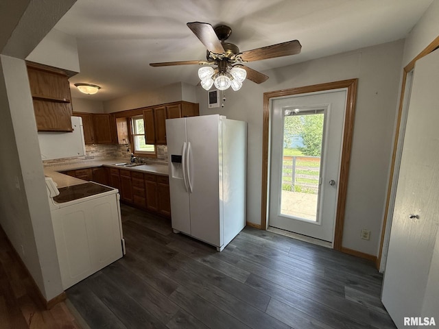 503 Lafayette St, Lafayette, IL 61449 - kitchen with white fridge with ice dispenser, stove, ceiling fan, dark wood-type flooring, and tasteful backsplash