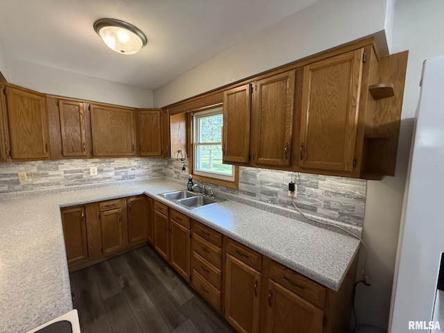 503 Lafayette St, Lafayette, IL 61449 - kitchen featuring dark wood-style flooring, brown cabinets, light countertops, and tasteful backsplash