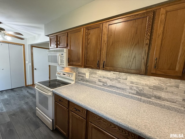 503 Lafayette St, Lafayette, IL 61449 - kitchen featuring white appliances, decorative backsplash, a ceiling fan, brown cabinets, and light countertops