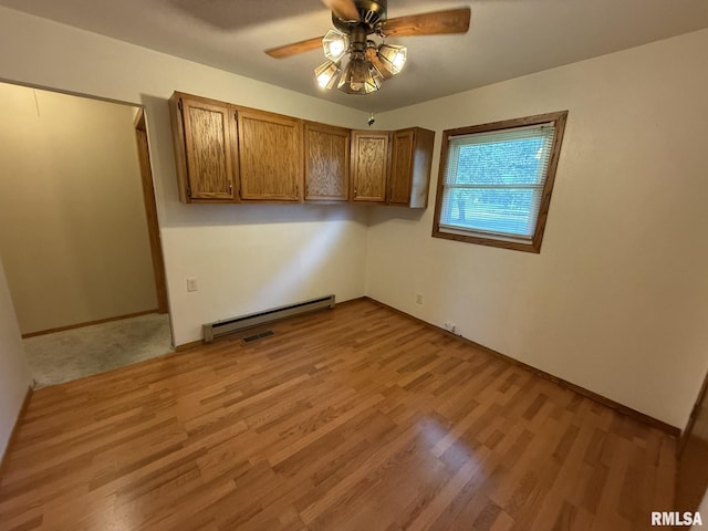 503 Lafayette St, Lafayette, IL 61449 - unfurnished room featuring a baseboard heating unit, ceiling fan, and wood finished floors