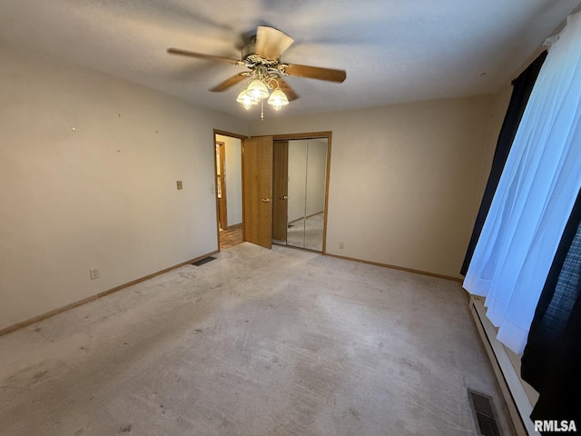 503 Lafayette St, Lafayette, IL 61449 - unfurnished bedroom featuring ceiling fan, light colored carpet, and a closet
