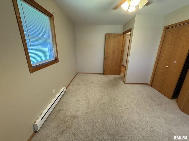 503 Lafayette St, Lafayette, IL 61449 - unfurnished bedroom featuring a baseboard heating unit, carpet floors, and ceiling fan