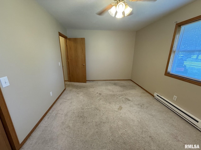 503 Lafayette St, Lafayette, IL 61449 - carpeted empty room with a baseboard heating unit and ceiling fan