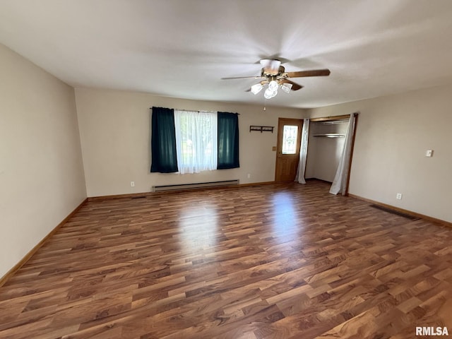 503 Lafayette St, Lafayette, IL 61449 - unfurnished living room featuring baseboard heating, wood finished floors, and a ceiling fan