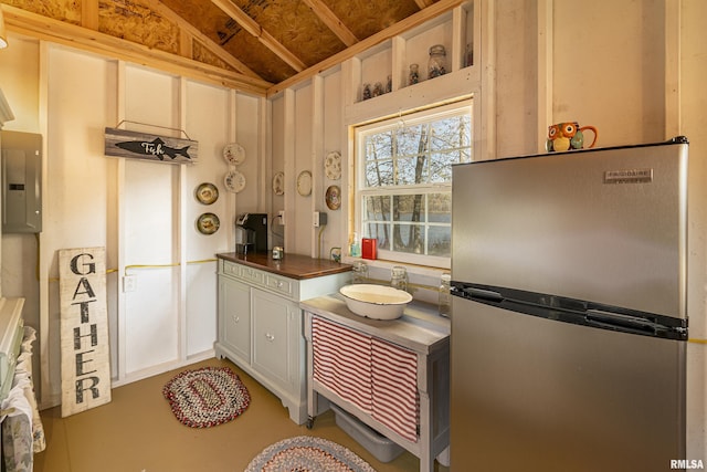2620 S Cambon Dr, West Frankfort, IL 62896 - kitchen featuring freestanding refrigerator, electric panel, vaulted ceiling, and dark countertops