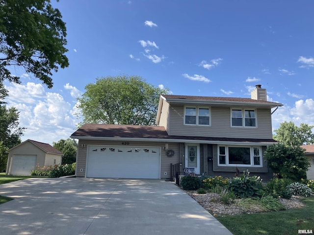 420 E Garfield St, Kewanee, IL 61443 - traditional-style home with a chimney, a garage, and concrete driveway