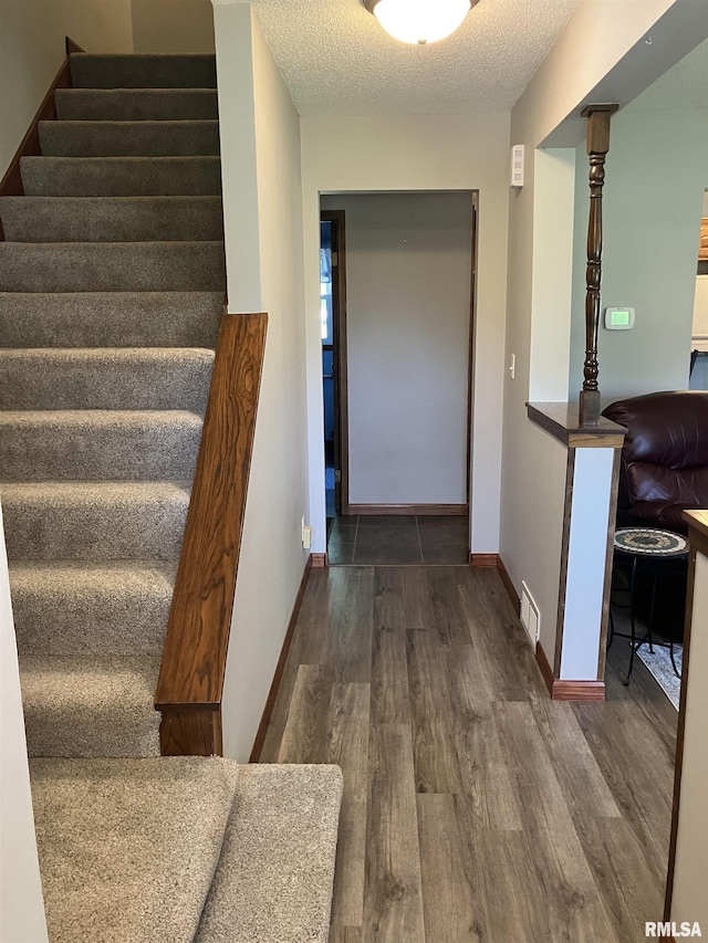 420 E Garfield St, Kewanee, IL 61443 - corridor with stairway, wood finished floors, and a textured ceiling