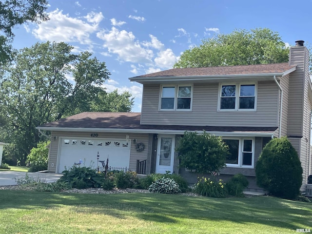 420 E Garfield St, Kewanee, IL 61443 - traditional-style home featuring a garage, a front lawn, and a chimney