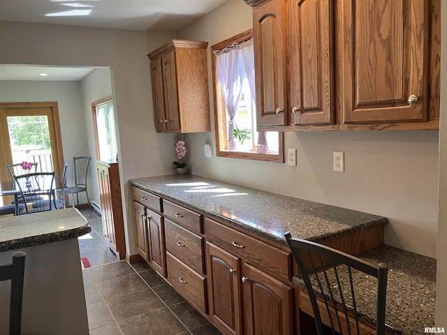 420 E Garfield St, Kewanee, IL 61443 - kitchen with brown cabinets and dark tile patterned flooring