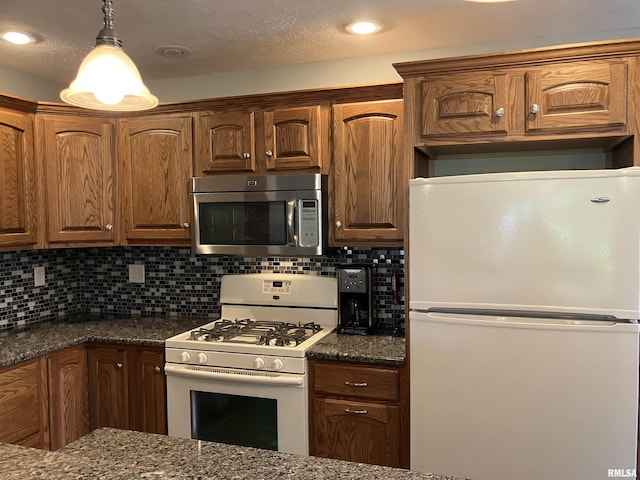 420 E Garfield St, Kewanee, IL 61443 - kitchen featuring white appliances, dark stone counters, decorative backsplash, pendant lighting, and recessed lighting