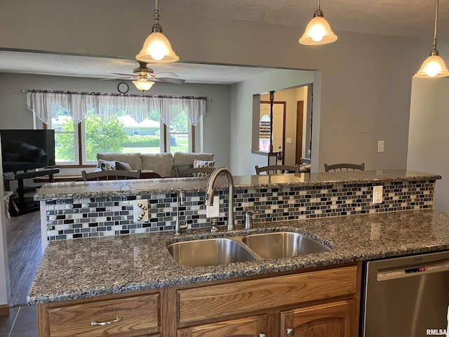 420 E Garfield St, Kewanee, IL 61443 - kitchen featuring stainless steel dishwasher, brown cabinetry, a ceiling fan, open floor plan, and pendant lighting