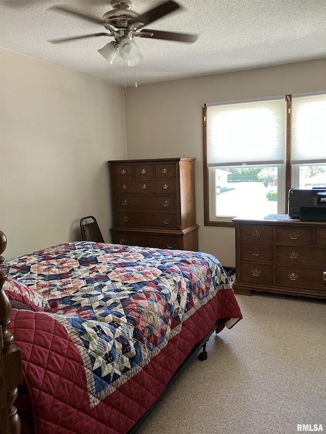 420 E Garfield St, Kewanee, IL 61443 - bedroom featuring light colored carpet, a textured ceiling, and a ceiling fan