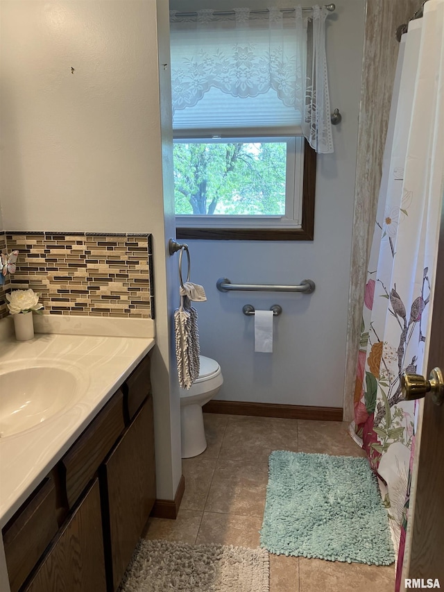 420 E Garfield St, Kewanee, IL 61443 - bathroom with tile patterned flooring, vanity, decorative backsplash, and curtained shower