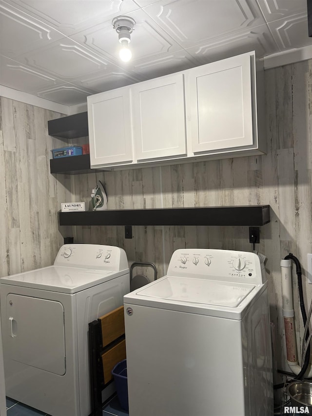 2008 W 70th St, Davenport, IA 52806 - laundry room with washing machine and dryer, cabinet space, and wooden walls