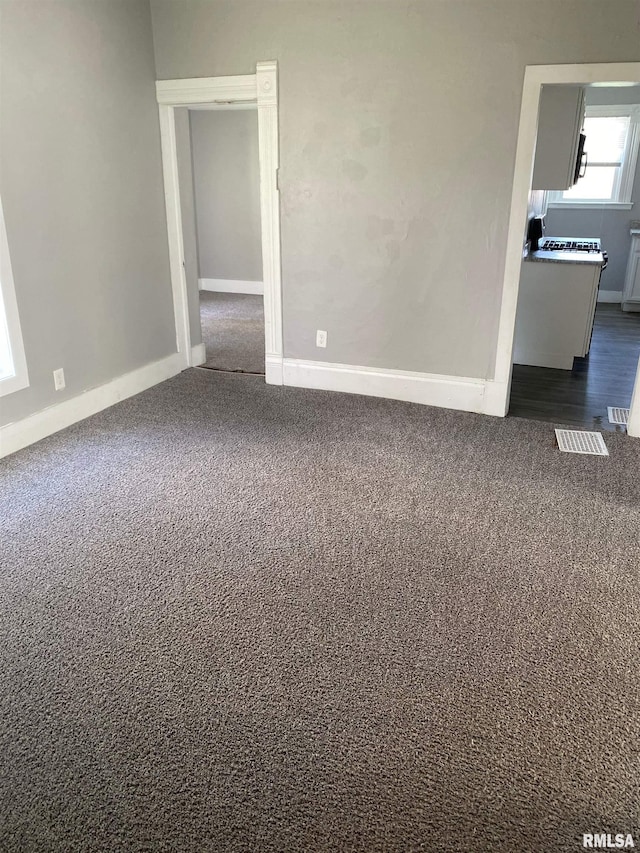 1923 Pershing Ave, Davenport, IA 52803 - unfurnished room with dark colored carpet and baseboards