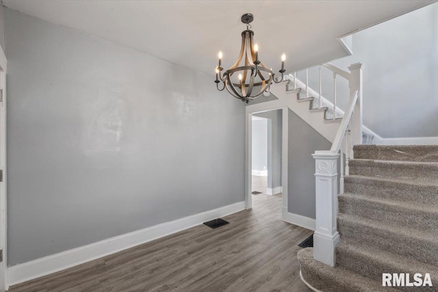 812 W 16th St, Davenport, IA 52804 - stairway featuring wood finished floors and a chandelier