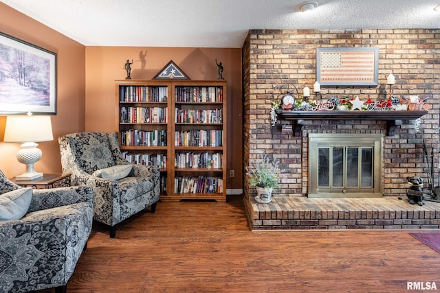 1814 Testa Dr, Marion, IL 62959 - sitting room with a textured ceiling, a brick fireplace, and wood finished floors