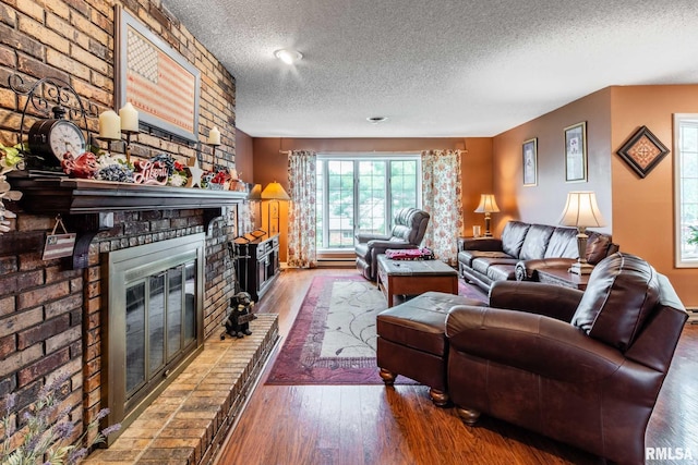 1814 Testa Dr, Marion, IL 62959 - living area featuring a textured ceiling, a fireplace, and wood finished floors