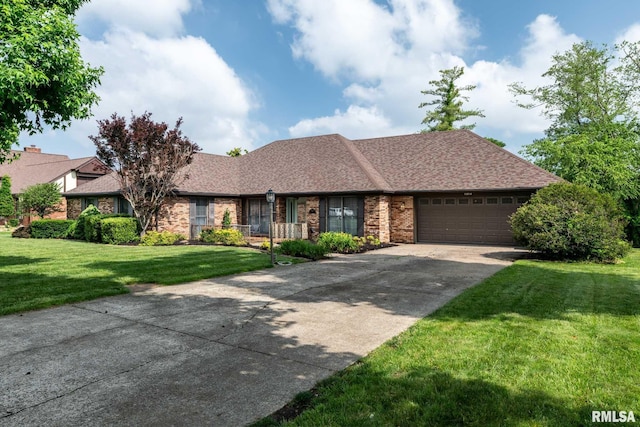 1814 Testa Dr, Marion, IL 62959 - view of front facade with a garage, a front lawn, driveway, brick siding, and a shingled roof
