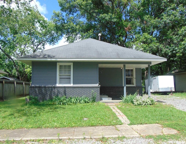 1306 Newton Ave, Johnston City, IL 62959 - bungalow with covered porch, brick siding, and roof with shingles