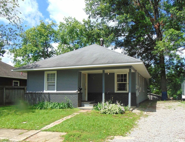 1306 Newton Ave, Johnston City, IL 62959 - bungalow-style home with brick siding, covered porch, and roof with shingles