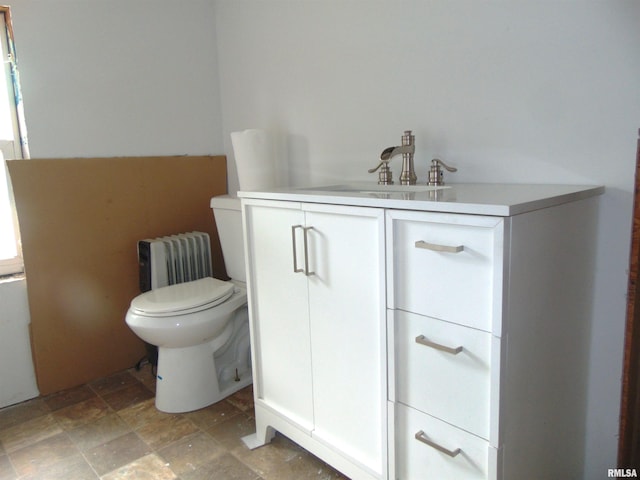 1306 Newton Ave, Johnston City, IL 62959 - bathroom featuring stone finish flooring, radiator, and vanity