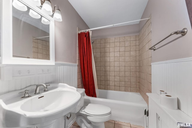 921 45th St, Rock Island, IL 61201 - bathroom with shower / tub combo with curtain, wainscoting, and tile patterned flooring