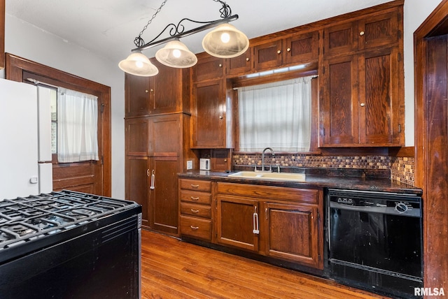 921 45th St, Rock Island, IL 61201 - kitchen with black appliances, dark countertops, tasteful backsplash, and wood finished floors