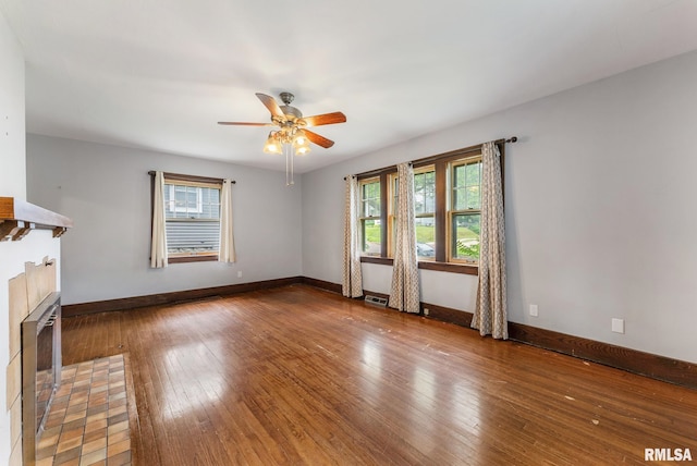 921 45th St, Rock Island, IL 61201 - unfurnished living room with healthy amount of natural light, wood-type flooring, and a ceiling fan