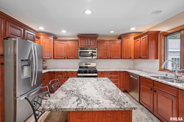10984 150th St, Davenport, IA 52804 - kitchen with stainless steel appliances, light stone counters, a kitchen island, a kitchen breakfast bar, and recessed lighting