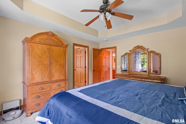 10984 150th St, Davenport, IA 52804 - bedroom featuring a raised ceiling, carpet, and a ceiling fan