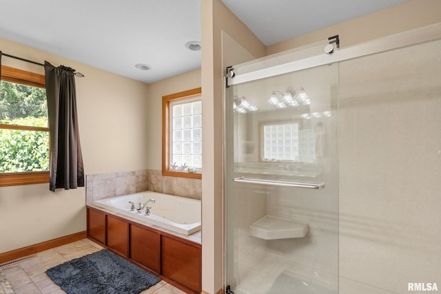 10984 150th St, Davenport, IA 52804 - bathroom with a bath, a shower stall, and tile patterned flooring