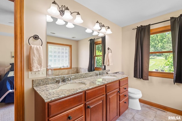 10984 150th St, Davenport, IA 52804 - bathroom with double vanity, ensuite bathroom, and tile patterned floors