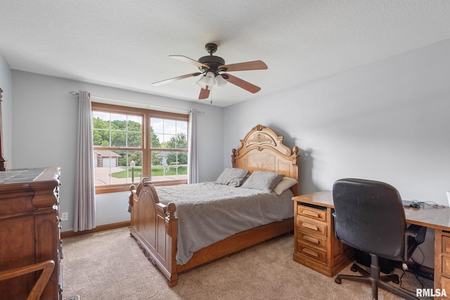 10984 150th St, Davenport, IA 52804 - bedroom with light carpet, a ceiling fan, a desk, and a textured ceiling