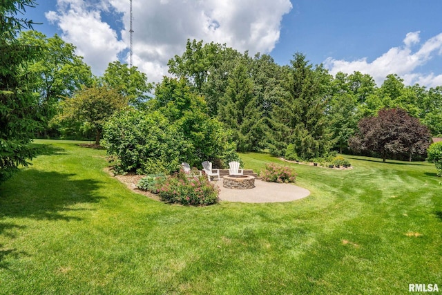 10984 150th St, Davenport, IA 52804 - view of grassy yard with a patio and an outdoor fire pit