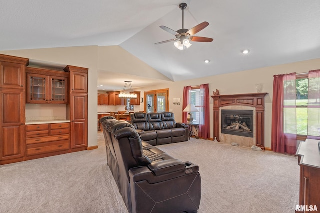 10984 150th St, Davenport, IA 52804 - living room featuring light colored carpet, lofted ceiling, a fireplace with flush hearth, healthy amount of natural light, and a ceiling fan