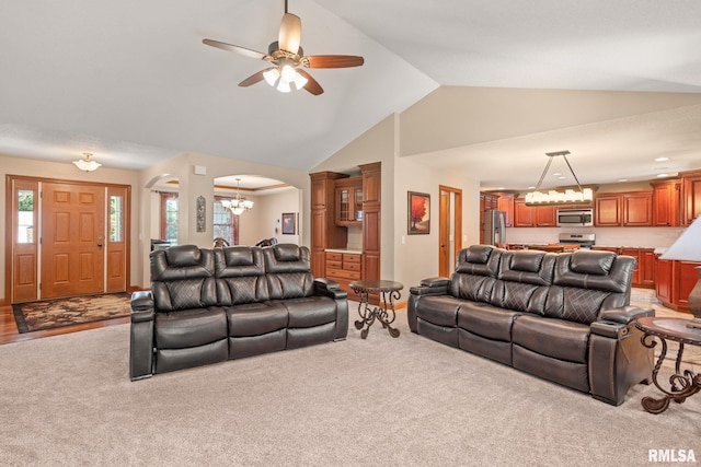 10984 150th St, Davenport, IA 52804 - living area featuring a chandelier, arched walkways, light colored carpet, ceiling fan, and high vaulted ceiling