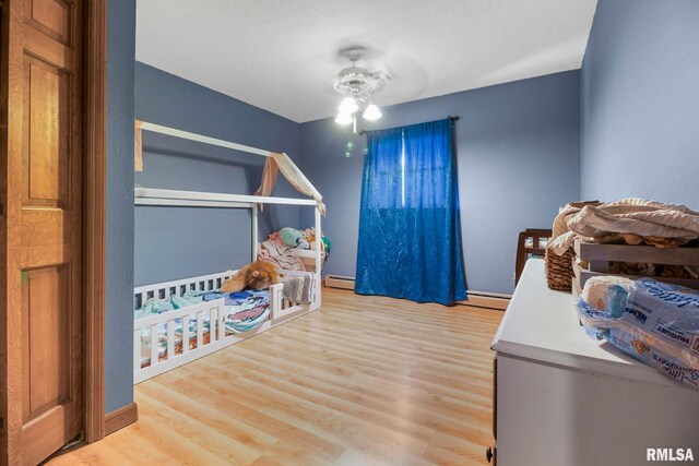 1406 Golf Course Rd, Marion, IL 62959 - bedroom featuring wood finished floors and a baseboard heating unit