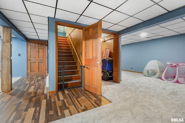 1406 Golf Course Rd, Marion, IL 62959 - finished basement with stairs, a paneled ceiling, carpet, wood finished floors, and wood walls