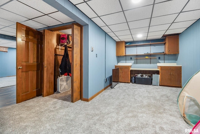 1406 Golf Course Rd, Marion, IL 62959 - kitchen with a drop ceiling, light carpet, brown cabinetry, and wood walls