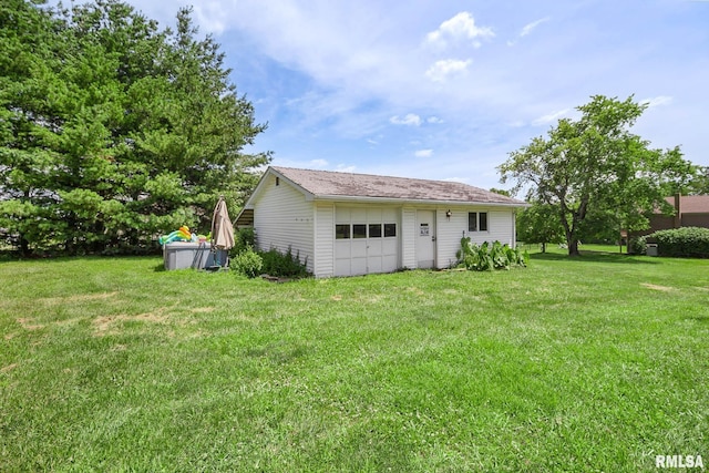 1406 Golf Course Rd, Marion, IL 62959 - back of house featuring a garage and a yard