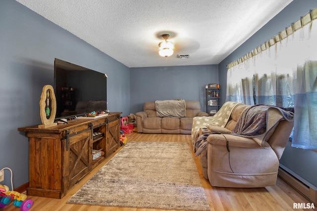 1406 Golf Course Rd, Marion, IL 62959 - living room featuring baseboard heating, wood finished floors, and a textured ceiling