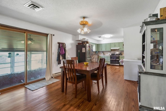 1406 Golf Course Rd, Marion, IL 62959 - dining room with dark wood-style floors, a textured ceiling, a ceiling fan, and a baseboard radiator