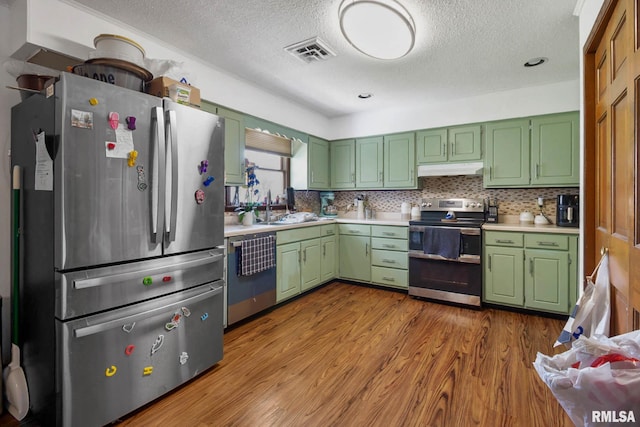 1406 Golf Course Rd, Marion, IL 62959 - kitchen featuring appliances with stainless steel finishes, green cabinets, a textured ceiling, and light countertops