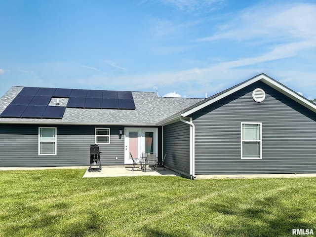 1612 N Garfield St, Marion, IL 62959 - back of property with a yard, solar panels, a patio area, and a shingled roof